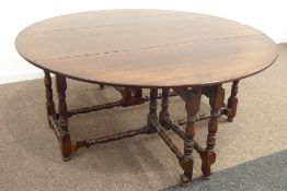 Large 17th century style oak dining table, oval drop leaf top, double gate action base,