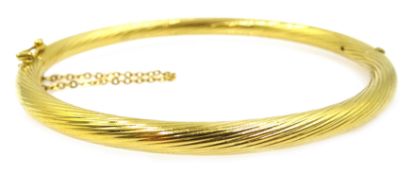 9ct gold twist design hinged bangle, stamped 375 and with import marks,