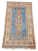 Turkish pale blue ground rug, decorated with stylised flower heads and geometric motifs,
