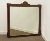 Early 20th century walnut framed overmantel mirror, shaped pediment with butterfly inlay,