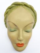 Art Deco wall mask of a lady, her eyes closed with braided hair, by the Leonardene Factory,