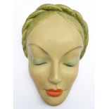 Art Deco wall mask of a lady, her eyes closed with braided hair, by the Leonardene Factory,