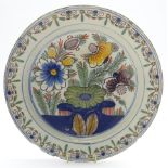 18th Century Dutch Delft plate decorated with stylised flowers in blue, green,