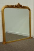 Gilt framed overmantel mirror, scrolled acanthus and cartouche pediment, bevelled glass plate,