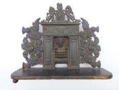 19th century cast iron miniature fire-grate, surmounted by royal coat of arms,