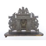 19th century cast iron miniature fire-grate, surmounted by royal coat of arms,