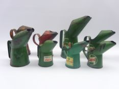 Eight vintage painted tin oil cans of various sizes for Castrol, Esso, Pratts and BP,