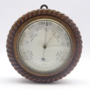 Late 19th century circular oak cased aneroid barometer in carved rope twist surround,