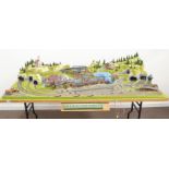 N-gauge - model railway layout in a mountainous Alpine style with multiple tracks and sidings,