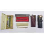 Propelling pencil in 9ct gold case inscribed 'The Mascot', two Cross gold plated pen sets,