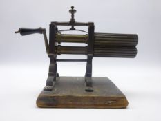 19th century brass and iron Fluting Iron with ebony turned handle, mounted on pine base,