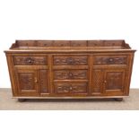 Late 18th century heavily carved oak dresser base, fitted with six upper drawers,