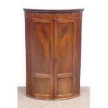 Early 19th century mahogany bow front wall hanging corner cupboard,