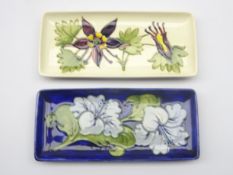 Two Moorcroft rectangular trays decorated in the Hibiscus and Columbine pattern,