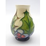 Moorcroft vase decorated with Holly & Berries, signed in gold pen Philip Gibson,