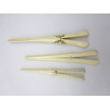 Two pairs of Chinese ivory glove stretchers both with carved detail and a Victorian ivory pair of