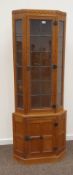 'Foxman' oak floor-standing corner cabinet, lead glazed door and display panels,