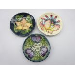 Three Moorcroft coasters - 'Frangipani' by Emma Bossons,