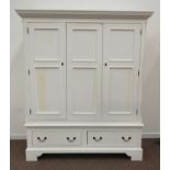 White painted triple wardrobe, projecting dentil cornice over three doors, two drawers to base,