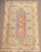 Turkish beige ground rug, geometric design decorated with flower heads (230cm x 165cm),