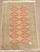 Persian Bokhara design peach ground rug (188cm x 127cm),