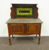 Late 19th/early 20th century oak Art Nouveau wash stand, raised splash back with green floral tiles,