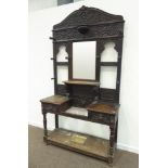 Large late Victorian heavily carved oak hall stand, scrolled acanthus leaf decoration,
