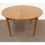 1970s circular teak extending dining table with foldout leaf, four tapering supports, H74cm,