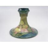 Moorcroft dwarf candlestick decorated in the Freesia pattern,