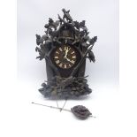 Late 19th century Black Forest type cuckoo clock, case heavily carved with animals, birds,