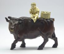 Late 19th century Japanese carved wood figure of a Buffalo with an ivory figure of a child seated