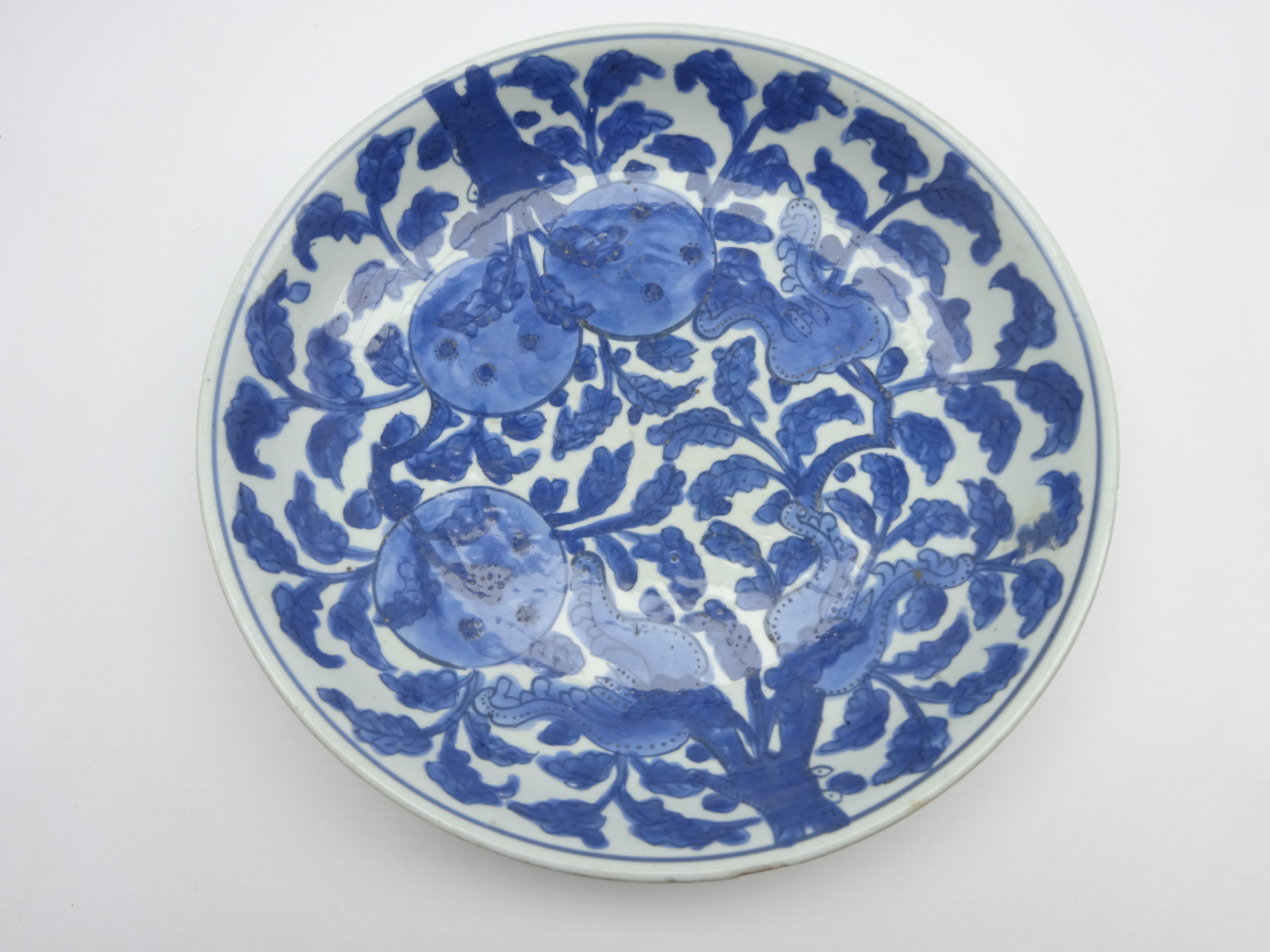 Chinese Kang Hsi shallow bowl decorated with fruit and flowers in blue and white 26cms Diam - Image 2 of 4