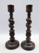 Pair of beech candlesticks of Ecclesiastical design with spiral turned columns and circular bases