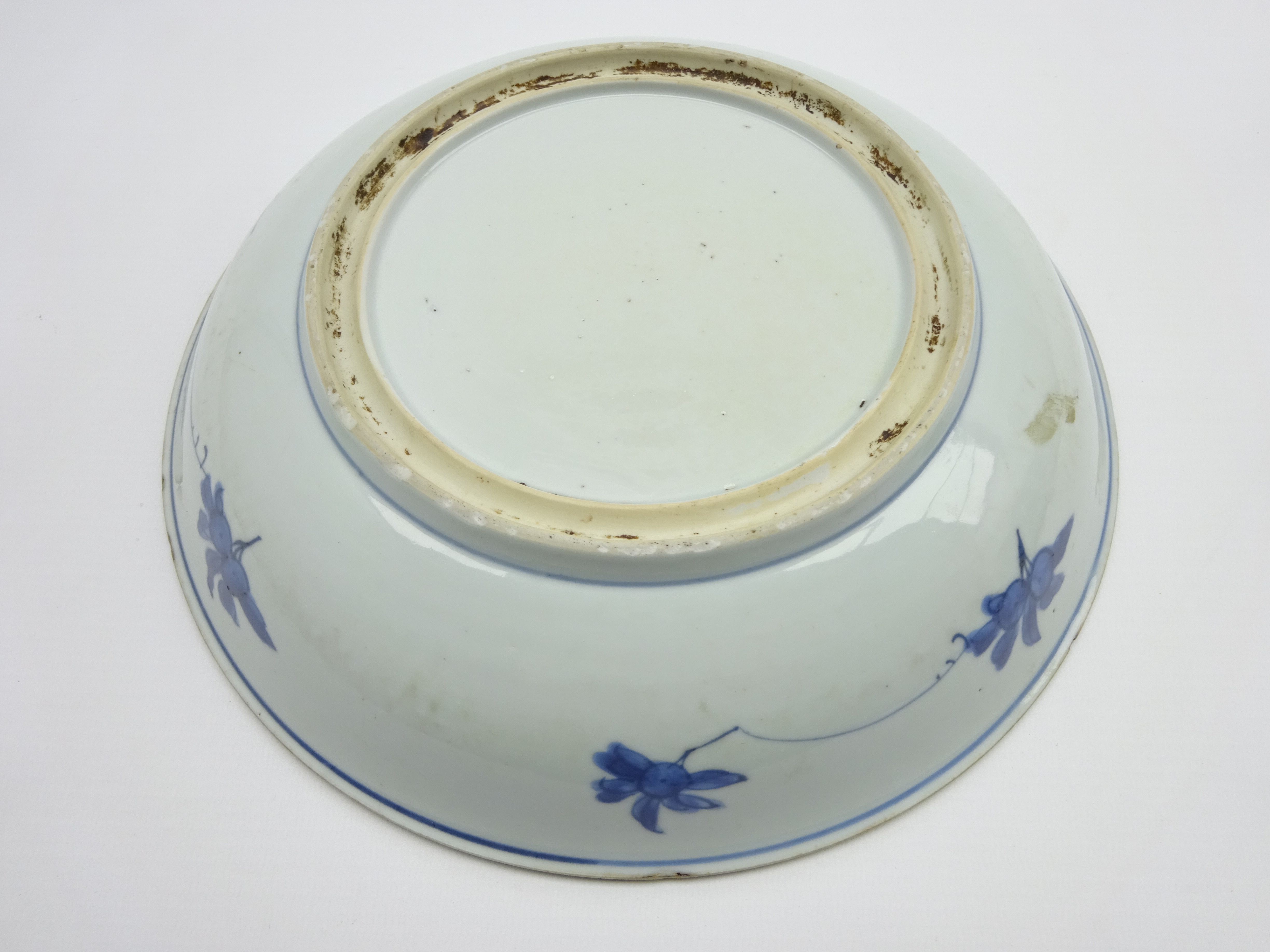 Chinese Kang Hsi shallow bowl decorated with fruit and flowers in blue and white 26cms Diam - Image 3 of 4