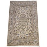 Persian ivory ground rug, decorated with scrolling foliage and central medallion,