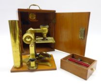 Small early 20th century brass monocular microscope with slides and other accessories,