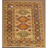 Turkish beige ground rug, the field decorated with four lozenge medallions, geometric star motifs,