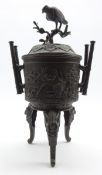 Late 19th Century Japanese bronze vase and cover, the lift formed as a bird on a branch,