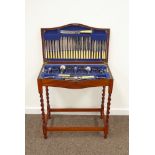 Early 20th century silver-plated canteen on oak barley twist stand,