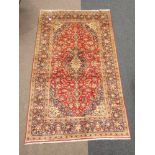 Persian Kashan golden red ground rug, field with overall interlaced floral decoration,