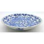 Chinese Kang Hsi shallow bowl decorated with fruit and flowers in blue and white 26cms Diam