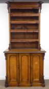 19th century oak and walnut bookcase on cupboard, projecting cornice above four tier bookcase,