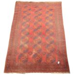 Large old Afghan Bokhara red ground rug, decorated with repeating tradition Guls,