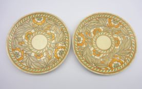 Pair of Crown Ducal Charlotte Rhead tube lined chargers with a pattern of leaves and flowers in