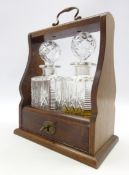 20th century mahogany tantalus with two square glass spirit decanters, hinged lockable front,