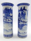 Pair of 19th century Chinese blue and white cylindrical vases decorated with figures and pagodas in