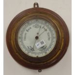 Early 20th century brass bulk head type barometer on circular moulded plaque,