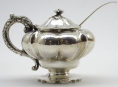 Early Victorian silver mustard pot of compressed circular design with loop handle and pedestal foot