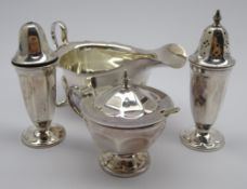 Silver sauce boat with crimped rim and loop handle and a three piece vase shape silver condiment