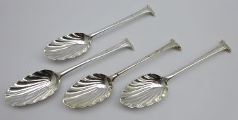 Set of 4 18th Century silver table spoons with fluted bowls and scroll finials,